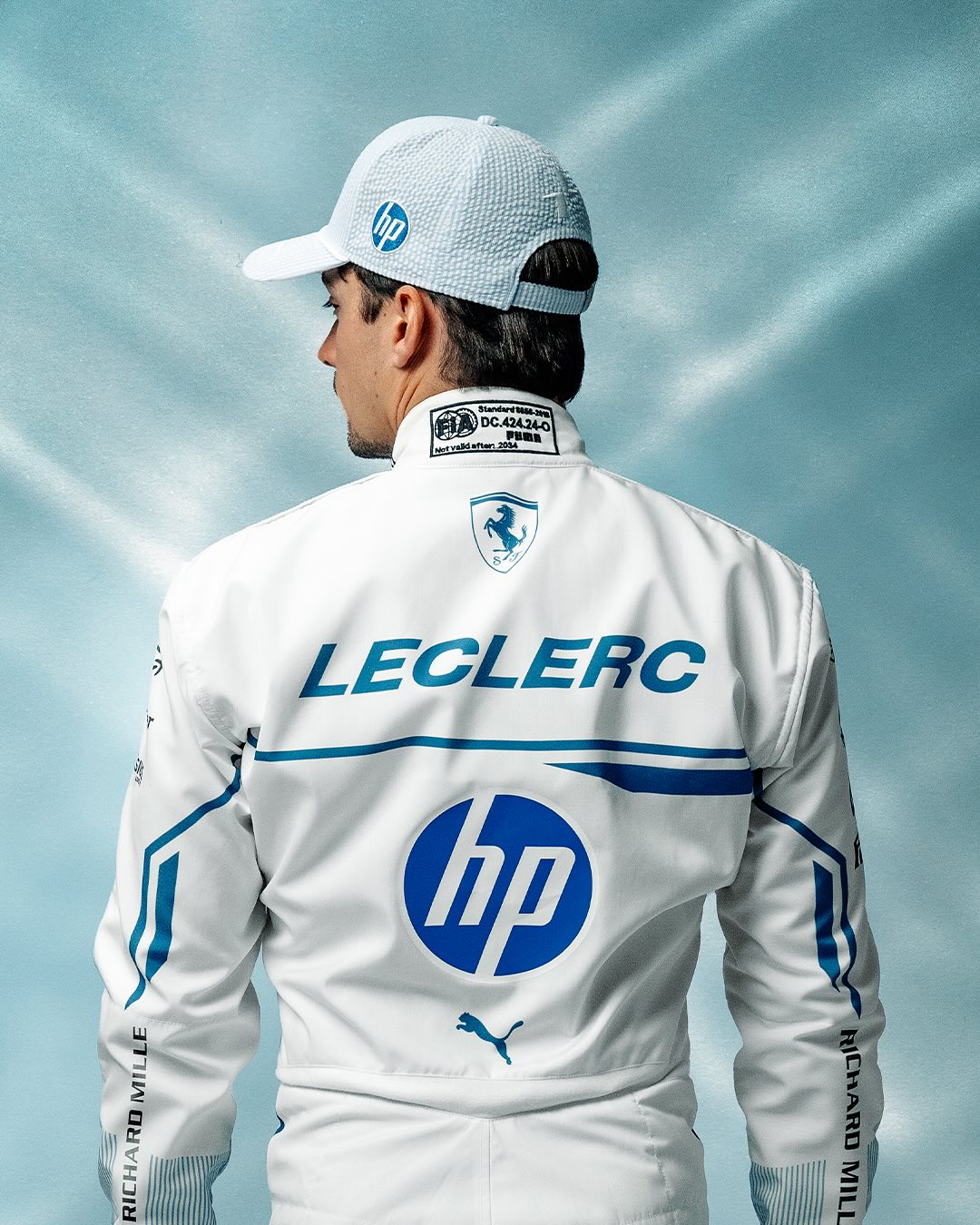 charles leclerc in a white driving suit